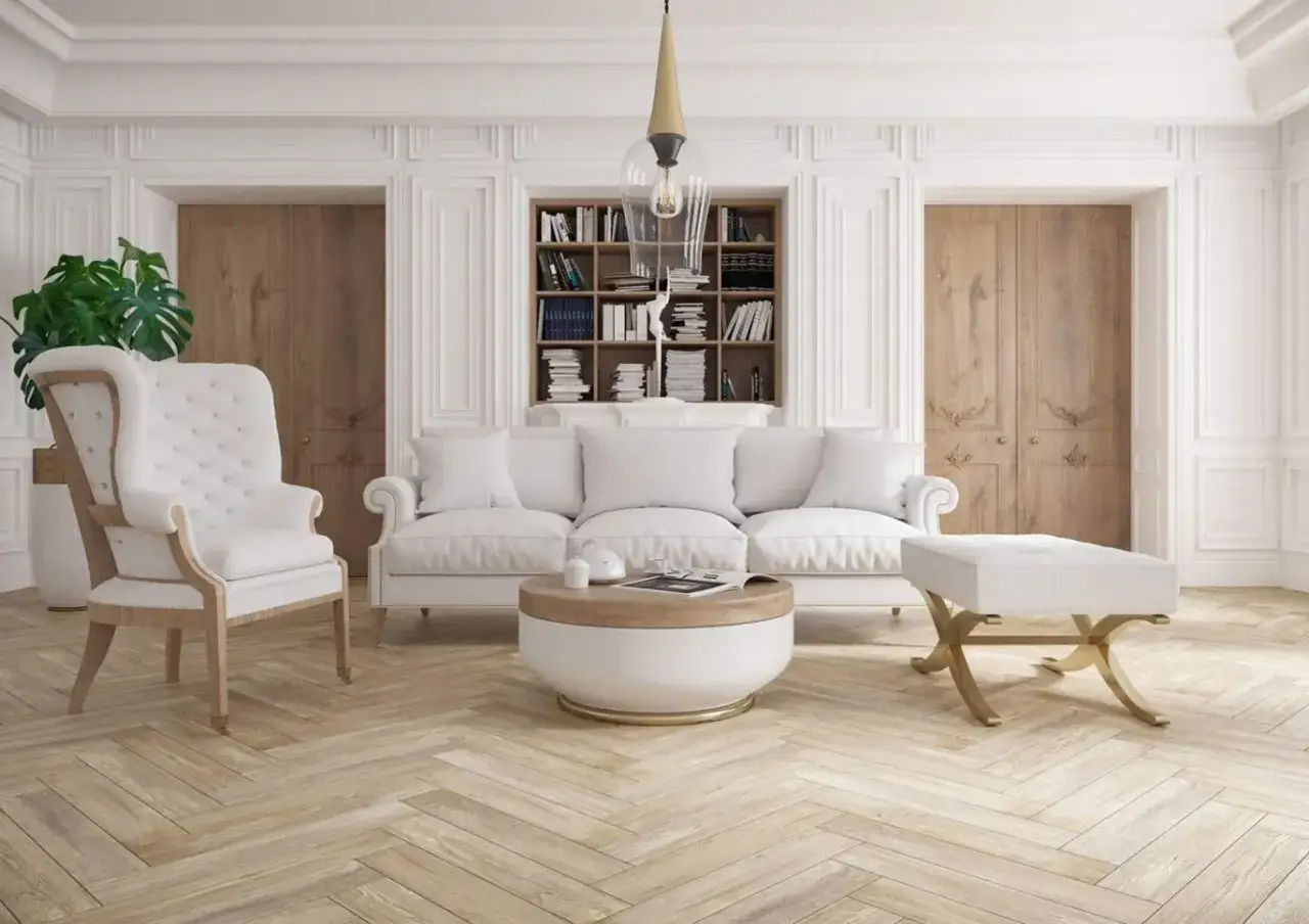 Elegancki salon z białymi meblami, regałem z książkami i ozdobnymi pilastrami na ścianach.